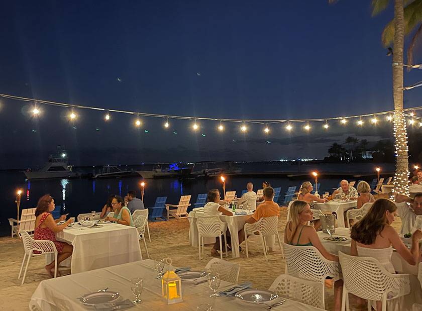 beachfront dinner under string lights